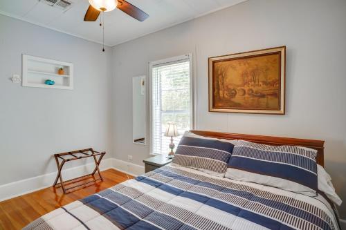 a bedroom with a bed and a painting on the wall at Lake Charles Vacation Rental - Walk to the Lake! in Lake Charles