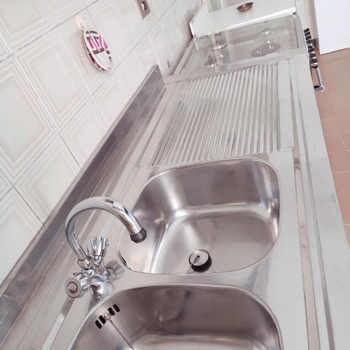 a stainless steel sink in a white kitchen at Casa Tanja in Pescara