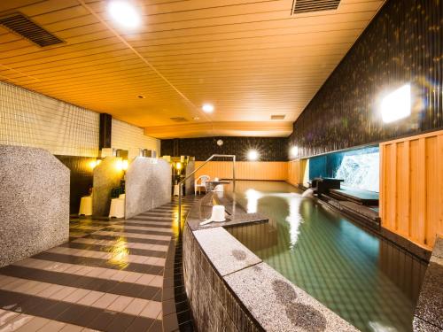a swimming pool in a building with a swimming pool at APA Hotel Osaka Tanimachi 4chome Ekimae in Osaka