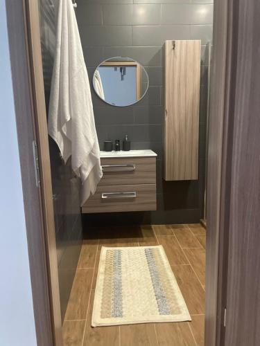 a bathroom with a sink and a mirror at Lizu Apartmant in Budapest