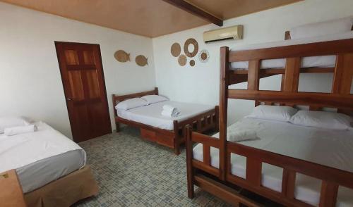 a bedroom with two bunk beds and a door at Bella Vista Hotel Boutique in San Miguel