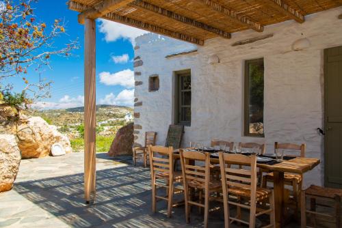 a table and chairs on the patio of a house at Sifnos Themonies in Apollonia