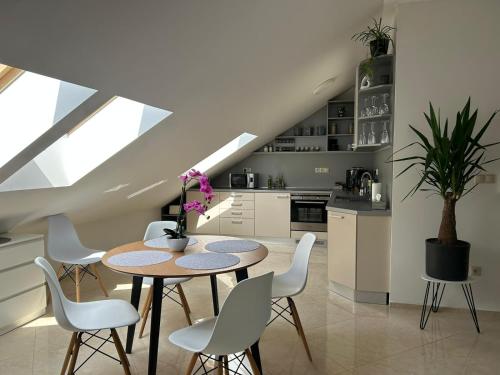 a kitchen and dining room with a table and chairs at LEO Apartment FREE PARKING - President Palace in Bratislava