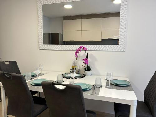 a dining room with a white table and chairs at LEO Apartment FREE PARKING - President Palace in Bratislava
