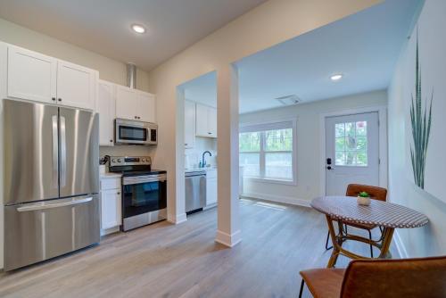 a kitchen with a stainless steel refrigerator and a table at DreamStay on Clay in Muskegon