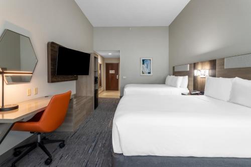 a hotel room with two beds and a desk at Holiday Inn Express Crystal River by IHG in Crystal River