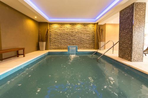 a pool in a hotel room with a swimming pool at Hotel Paucam in Santa Teresita
