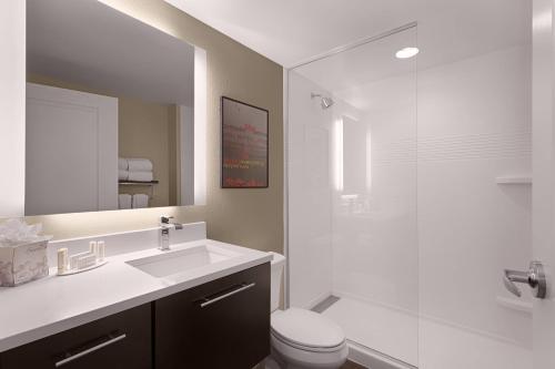 a bathroom with a sink and a toilet and a mirror at TownePlace Suites by Marriott Charleston Mt. Pleasant in Charleston