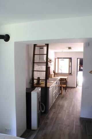 a room with a kitchen and a dining room at Casa Cucuc in Frisanco