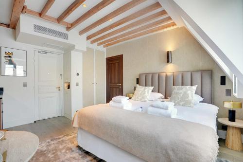 a bedroom with a large bed with white sheets at Amazing studio - Louvre Place Vendome in Paris