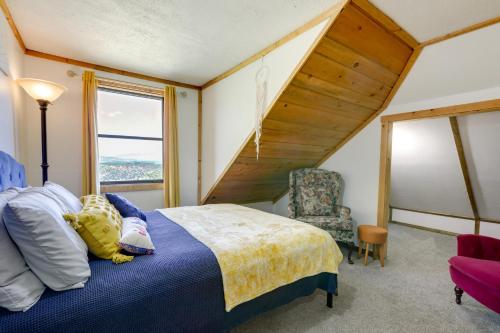 a bedroom with a bed and a chair and a window at Historic Alpine Cabin with Scenic Mount Sopris View in Glenwood Springs