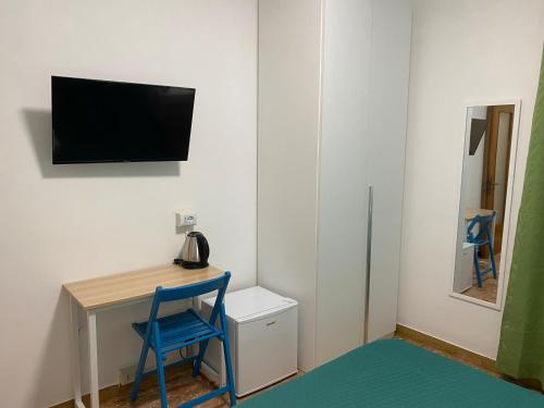a room with a desk and a tv on a wall at venice popular residence in Mestre