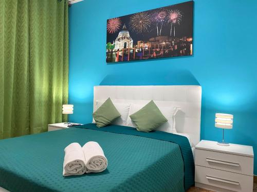 a blue bedroom with a bed with towels on it at venice popular residence in Mestre