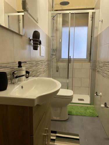 a bathroom with a sink and a toilet and a shower at venice popular residence in Mestre