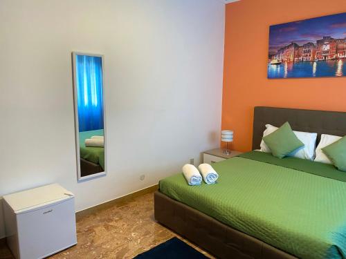 a bedroom with a green bed and a window at venice popular residence in Mestre