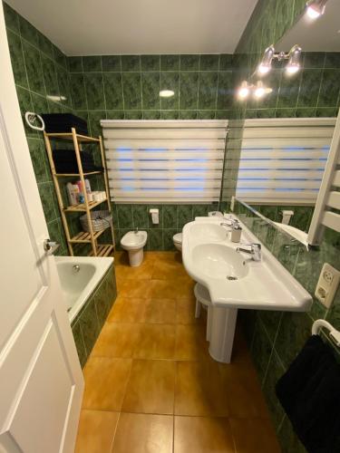 a bathroom with a sink and a tub and a toilet at MASIA LA MOLINERA in Xerta