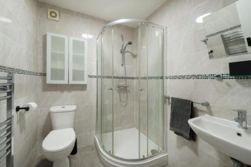 a bathroom with a shower and a toilet and a sink at Private house seconds from Portobello Road in London