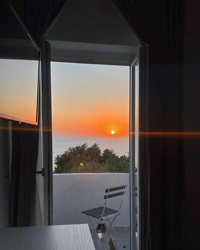 a view of a sunset from a room with a window at B&b Villa Jasmine in Palinuro
