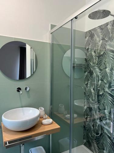 a bathroom with a sink and a glass shower at B&b Villa Jasmine in Palinuro