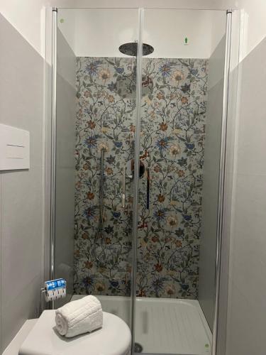 a shower with a glass door and a toilet in a bathroom at B&b Villa Jasmine in Palinuro