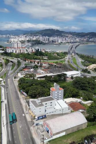 an aerial view of a city with a highway at Ok Inn Hotel Floripa in Florianópolis