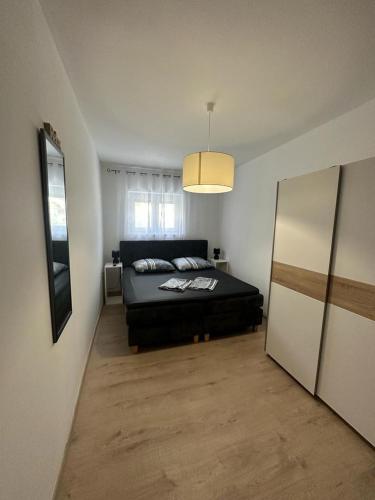 1 dormitorio con cama negra y ventana en Apartments Stinjan, en Pula