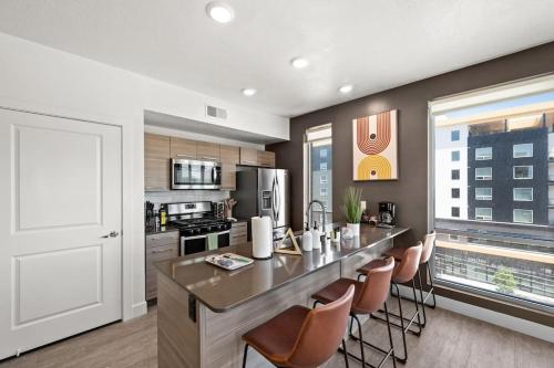 a kitchen with a large island with bar chairs at LUX 2 BD BOHO in heart of SLC in Salt Lake City