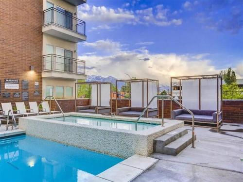 a swimming pool on a patio next to a building at LUX 2 BD BOHO in heart of SLC in Salt Lake City