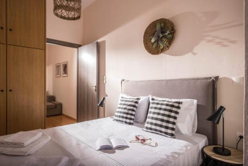 a bedroom with a bed with two books and a clock on the wall at Casa Irini in Spílion