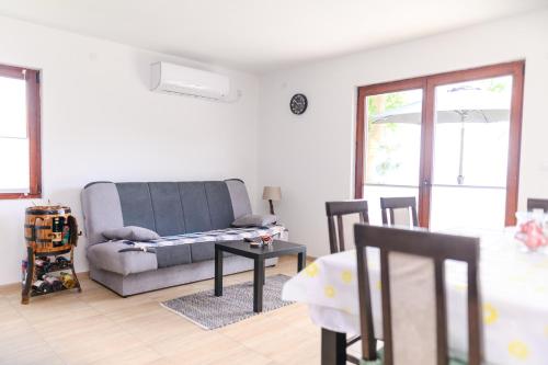 a living room with a couch and a table at Green House Latin Grad in Vrmdža