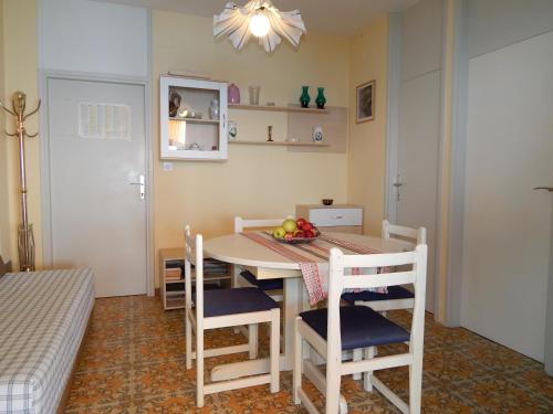a kitchen with a table and chairs with a bowl of fruit at Villa Maristika in Omiš