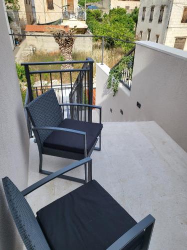 a pair of chairs sitting on a balcony at View in Komiža