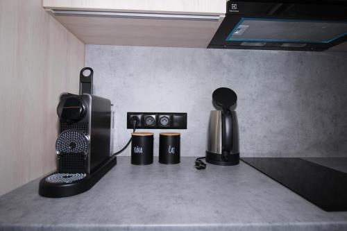 a kitchen counter with a coffee maker and a microwave at A2 Apartment & Studio - Hrabovo, Ružomberok in Ružomberok