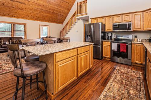 a kitchen with wooden cabinets and a counter top at Dancing Bear Lodge in McHenry