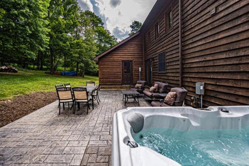 a hot tub on a patio next to a house at Dancing Bear Lodge in McHenry