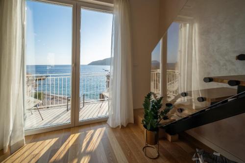 a room with a large window with a view of the ocean at View in Komiža