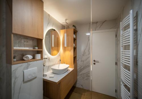 a bathroom with a sink and a mirror at View in Komiža