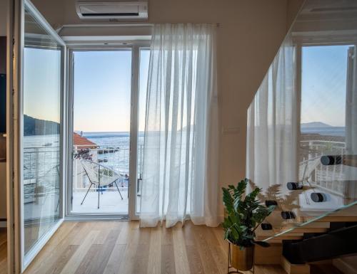 a living room with a large glass door with a view at View in Komiža