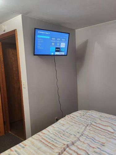 a flat screen tv on the wall of a bedroom at private upper 1 bd apartment in Buffalo
