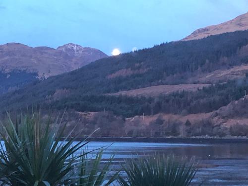a view of a lake with mountains in the background at Heron’s View in Arrochar