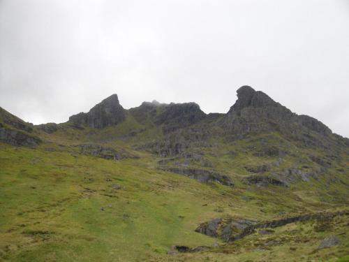a grassy hill with a mountain in the background at Heron’s View in Arrochar