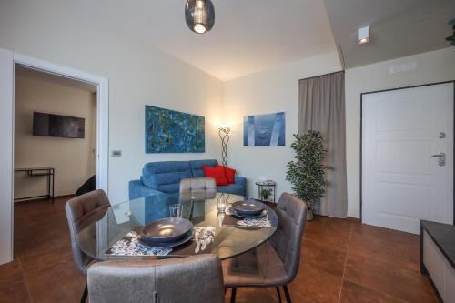 a living room with a table and a blue couch at Visconti 46 Central Apartments in Bari