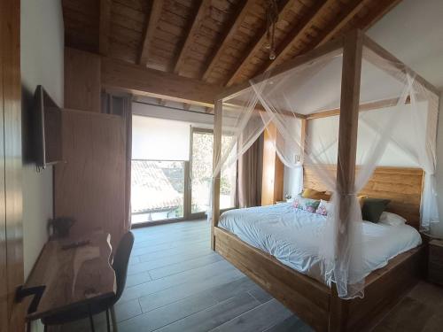 a bedroom with a canopy bed and a wooden floor at MIRADOR DEL HITO I y MIRADOR DEL HITO II in Espinosa de Bricia