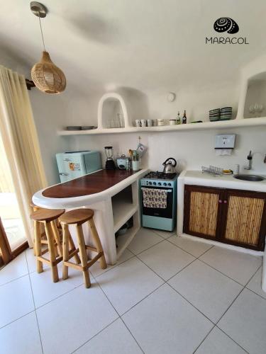 a kitchen with a table and chairs and a stove at Maracol Bungalows Vichayito in Vichayito
