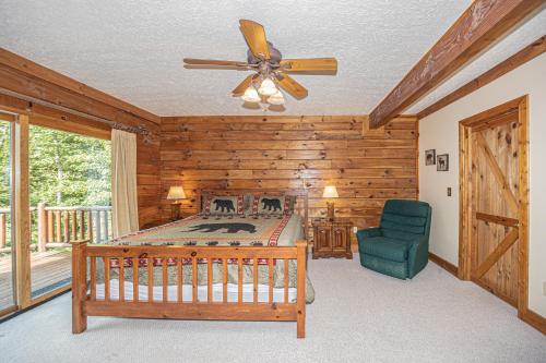 a bedroom with a bed and a ceiling fan at Big Bear in McHenry