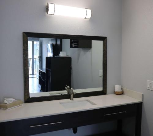 a bathroom with a sink and a large mirror at Motel 6-San Diego, CA - Southbay in Chula Vista