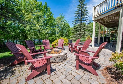 a group of red chairs sitting around a fire pit at Mallard Landing in McHenry