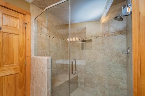 a bathroom with a shower with a glass door at Mallard Landing in McHenry
