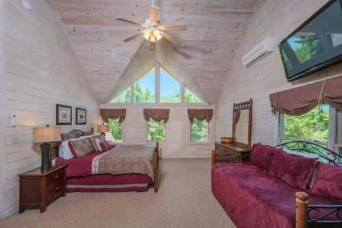 a bedroom with a bed and a couch and a ceiling fan at Mallard Landing in McHenry