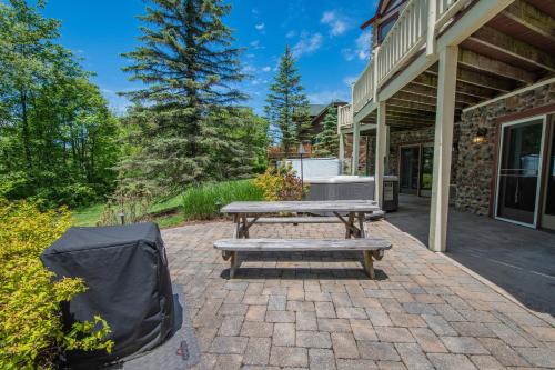 a picnic table on a brick patio in front of a house at Mallard Landing in McHenry